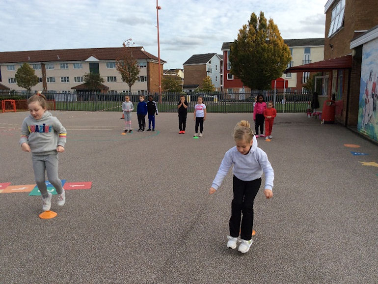 Children enjoying athletics activities in the playground