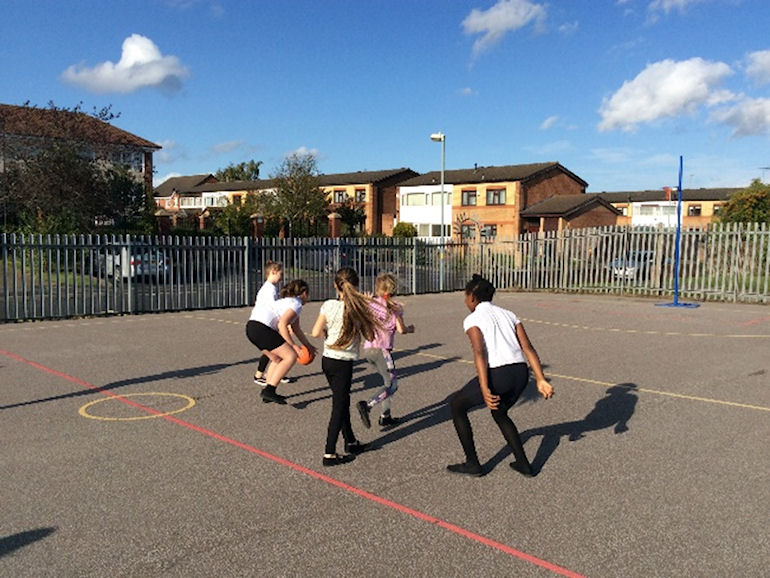 A netball match in action on the school playground